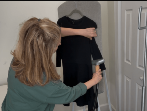 "woman steam cleaning black dress"